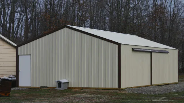 Cream building with a dark roof, a sliding door and a white walk door on gravel