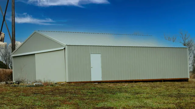 Pale green machine shed with a sliding door and a walk door