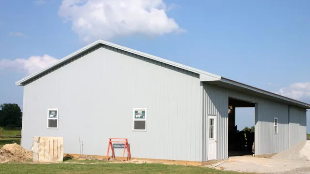 White barn with a drive-through opening and windows along the wall