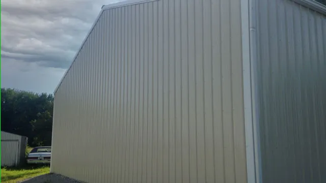 Close view of cream steel siding running up a barn wall