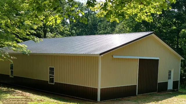 Cream barn with a brown roof and wainscot, a sliding door and windows