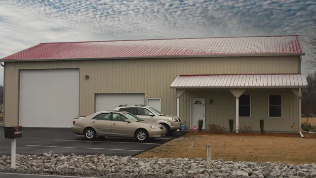 Cream commercial building with a red roof, an overhead door and an entry canopy