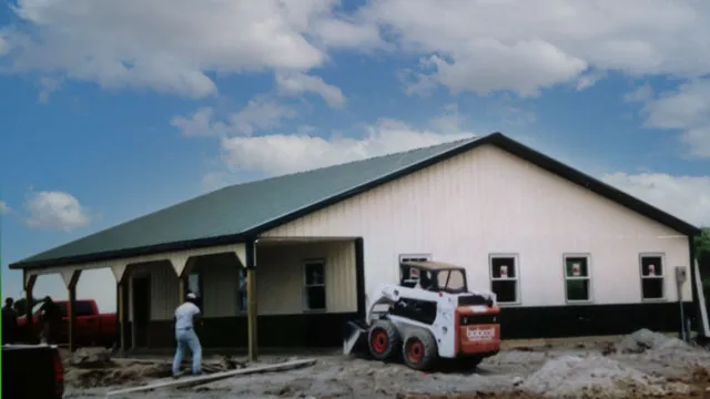 White building with a green roof and a cantilever porch, still under construction