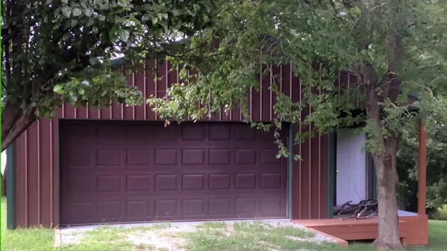 Maroon building with an inset porch and an overhead door
