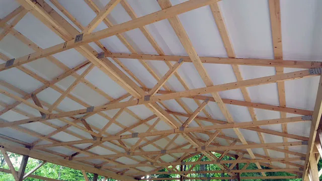 Insulation lining the underside of a metal roof