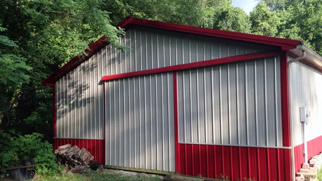 Silver barn with red trim and a sliding door