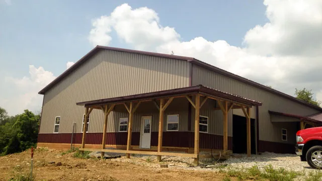 Tan building with a long timber-post porch along the front