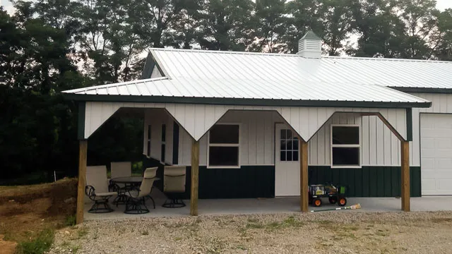 Cream building with green wainscot, a white roof and a timber-post porch with furniture under it