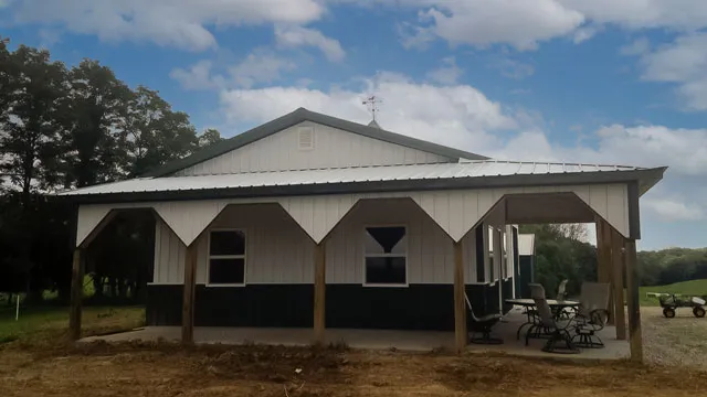 Cream building with a green roof and a long porch on timber posts