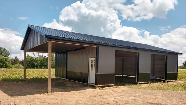 Bronze building with a dark roof and an open pole shed on timber posts across the front