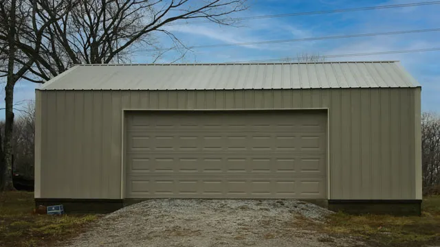 Sage green shop with a matching green roof and one wide overhead door