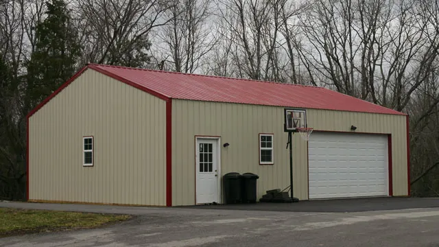 Tan shop with a red roof and red trim, a white overhead door, a walk door and two windows