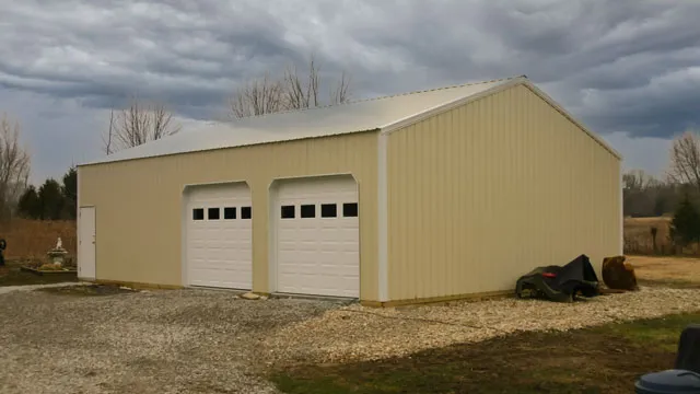 Tan shop with two white overhead doors standing on gravel
