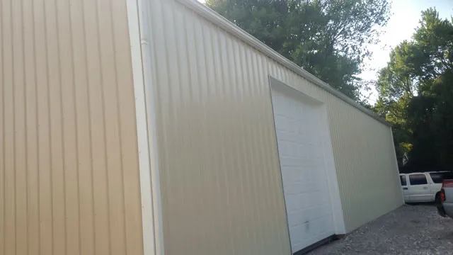 Long cream building with a tall white door at the far gable end