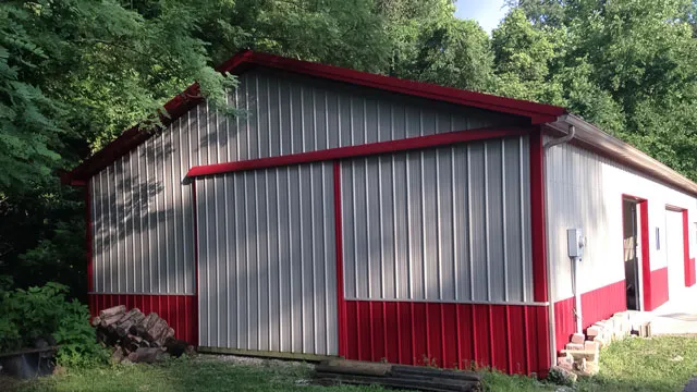 Silver-gray building with red trim, red wainscot and a red gable