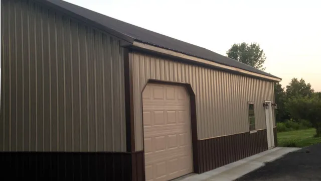 Tan building with a dark brown roof and wainscot and a tan overhead door