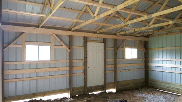 Inside a post frame building — trusses, purlins, white steel lining and two windows